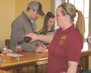 A Stone Hill Winery employee pours wine during a tasting that came with a $2.50 wine cellar tour.