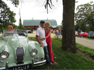 Peter and Sarah Botham leaning against her late Father's Jaguar 