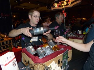 Lucas Gilhousen, winemaker for Crow River Winery located in Hutchinson, Minnesota, pours a sample of South Fork.  Gilhousen explains Crow River's American red wine with a blend of 60% Frontenac, 20% Marquette, and 20% Red Zinfandel.