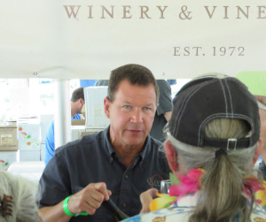 Bill Oliver, president of Oliver Winery in Bloomington serves a customer. 