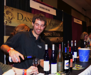 Luke Sombke wine maker for Danzinger Vineyards from Alma, Wisconsin pours a sample of their Twilight Delight (Marquette and Saint Croix grapes). 