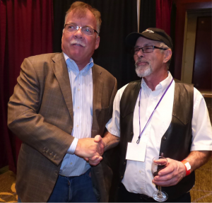 Two infamous Minnesota vineyard and winery owners Paul Quast from Saint Croix Vineyards and Don Millner from Millner Heritage Vineyard and Winery shake hands for a photo opp. 