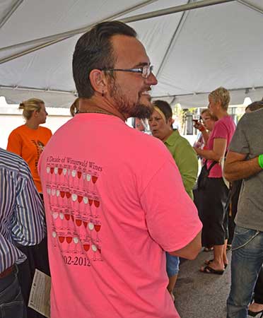 Fred Hillenbrand, assistant wine maker at Winzerwald Winery, wears winery's menu on his back. Hillenbrand will be manger of the tasting room Winzerwald is opening in Evansville.