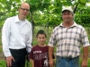 Midwest Wine Press Publisher, Mark Ganchiff and Two Oaks Vineyard owner John Harp with his grandson, William in front of Norton vines in April, 2012. 
